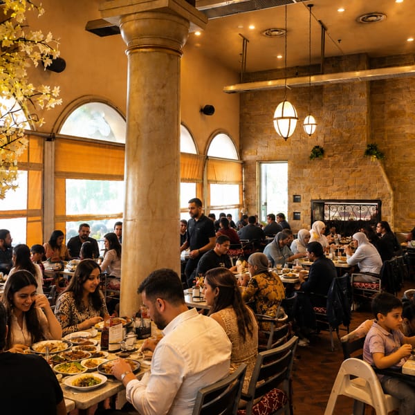 Diners enjoying meals in a bustling restaurant with a decorative lighted tree and stone walls.